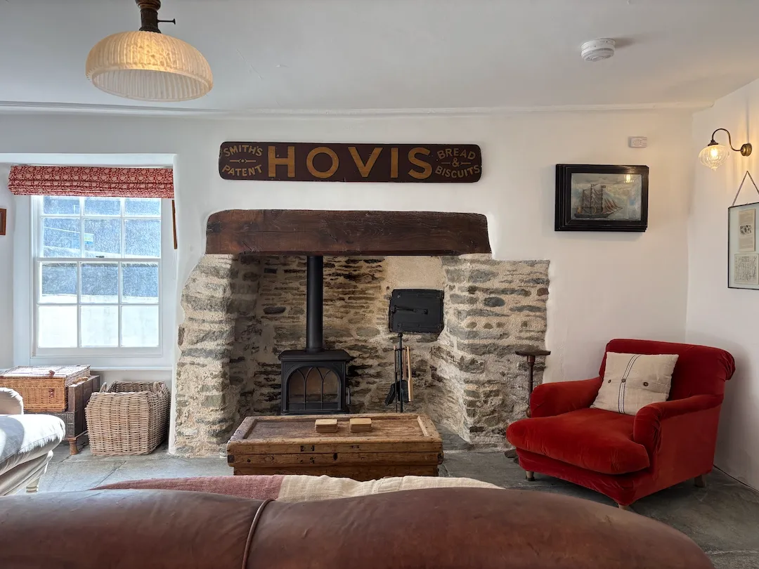 Cosy sitting room with inglenook fireplace and wood burning stove