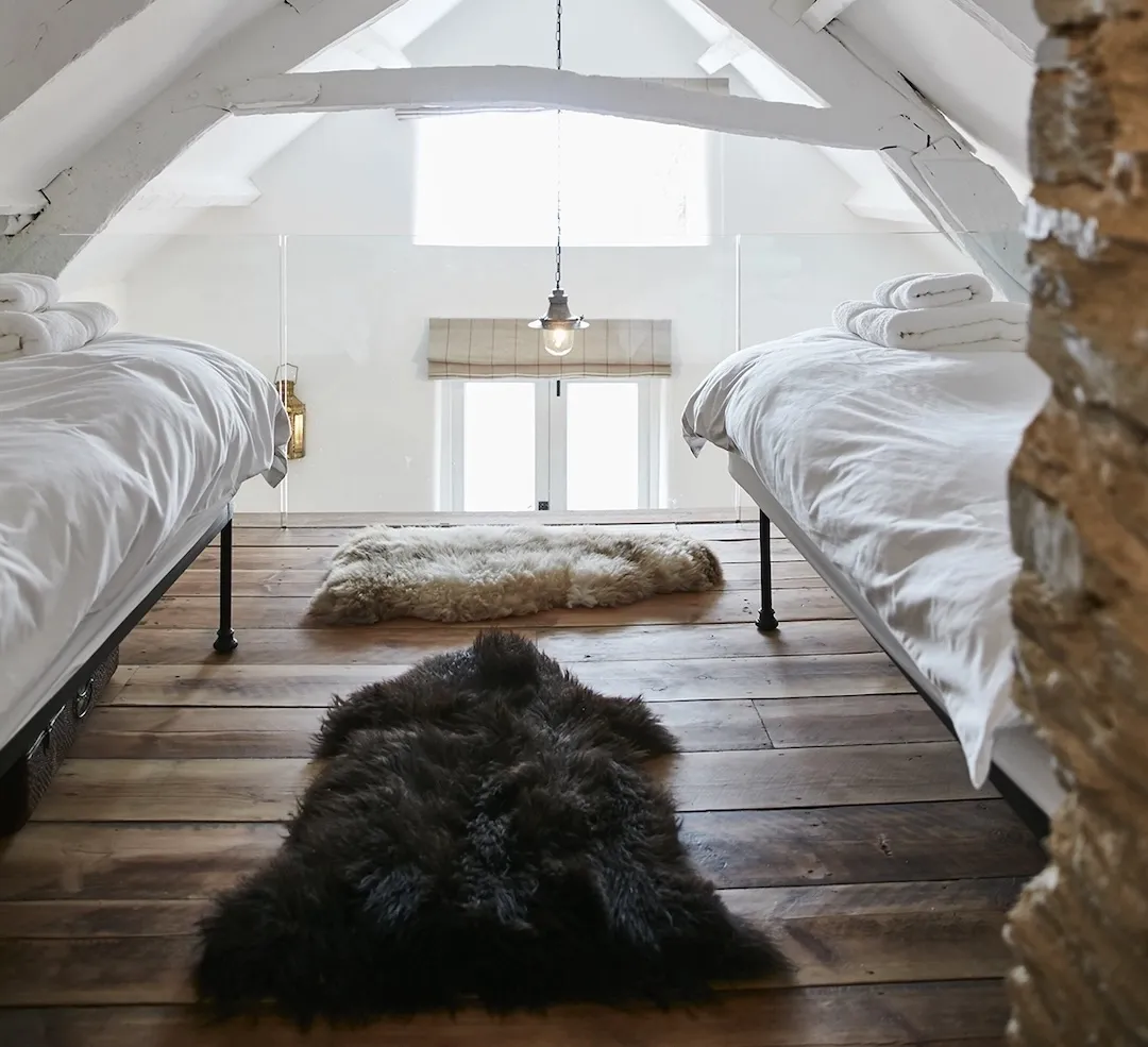 Bedroom 2 twin single beds on the loft floor with high level sea view window